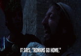 IT SAYS, "ROMANS GO HOME."