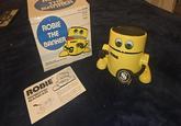 TH BANKER ROBIE THE BANKER ROBIE Feed him a coin and watch as he licks his chops Requires "AA" batery ROBIE®™ ROBOTIC BANKER Cat No.80-2261 Meet Robie the Robotic Banker, His favorite food is a coin. And he is so hungry he eats all the coins you feed him. But before you can feed him, you have to install a battery, so that Robie has enough energy to eat. 1. Open the battery compartment by Cat Ne 60-2261 60-2261 $9.95 ROBIE