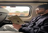 A photo of Hasan Piker reading Lenin.