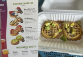 SED PROTEIN WAFFLES $4.99 09 GE $13.09 0 cal 1-30 cal on, 0 cal JONAL PROTEIN PROTEIN 13 8g* Berry Shortcake 2 protein waffles topped with fresh strawberry, blueberry, blue vanilla cashew drizzle, coconut whip 230 cal Go Bananas 2 protein waffles topped with banana, peanut butter, chocolate cashew drizzle 290 cal PROTEIN 12 8g Jam Slam 2 protein waffles topped with fresh strawberry, peanut butter, strawberry chia jam 240 cal Waffacado +$1 2 protein waffles, avocado, everything bagel seasoning 220 cal Facilityises WELLNESS SHOTS Ginger wellness and energy 10 cal $3.99 Turmeric inflammation fighter 20 cal Liver Boost detox and gut health 10 cal
