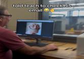 A photo of a teacher looking at a realistic troll face on his email. This is part of a prank.
