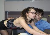 A photograph of Isabella Scaffidi leaning over Conor David Scheinberg at an office, taken for Omighty.