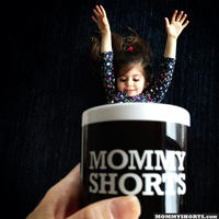 classical baby mugging of mug with cute mommy quote on it with lively child exiting from the cup like a yummy drink
