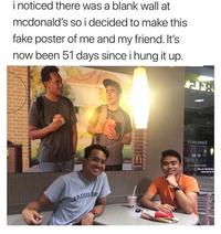 i noticed there was a blank wall at mcdonald's so i decided to make this fake poster of me and my friend. It's now been 51 days since i hung it up. ni no smoɔ (mlovin it The Der e #ADUA INC Clothing Shirt Product Smile Human Sleeve Sharing T-shirt Happy Community Line Font Adaptation Chair Friendship