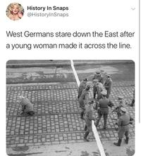 History In Snaps @HistorylnSnaps West Germans stare down the East after a young woman made it across the line. Berlin Wall West Berlin East Berlin West Germany Helmet Vertebrate Military uniform Military person Soldier Adaptation Army Military organization