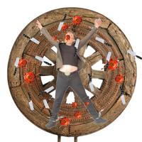 Elon Musk strapped to the spinning wheel with tomataoes and knives