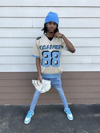 A Black man wearing blue skinny jeans, an Osaivier shirt and a blue beanie flexing cash in a fit pic. The image was later "photoshopped":https://knowyourmeme.com/memes/sites/photoshop to show him with one leg. Another edit showed him as a rocket ship. The image later inspired video creator "Jeremiah Springfield":https://knowyourmeme.com/memes/people/jeremiah-springfield