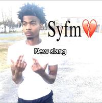 An image of "rapper":https://knowyourmeme.com/memes/cultures/rap-hip-hop Lazer Dim 700, from the "SYBAU Guy":https://knowyourmeme.com/memes/sybau-%F0%9F%92%94-lazer-dim-700 "meme":https://knowyourmeme.com/memes/memes, with SYFM instead of "SYBAU":https://knowyourmeme.com/memes/sybau written.