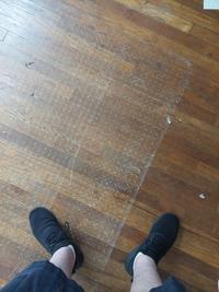 The plastic mat under a computer desk to protect the floor