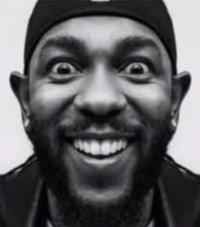 An edited image of Kendrick Lamar staring forward and smiling. The image comes from a Chanel ad which shows half of Lamar's face. The image has been copied, mirrored, and edited together.
