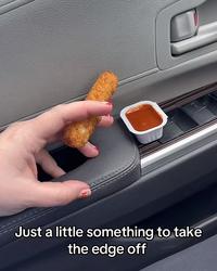 A photo of a person holding a mozzarella stick, captioned, "Just a little something to take the edge off."