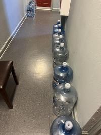 My neighbour leaves water jugs outside the apartment