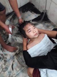 A photo of the two year old son dipped in tar after being cleaned off.