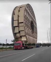 A truck hauling a building