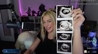 A screenshot of streamer Fandy. She is holding up ultrasound pics.