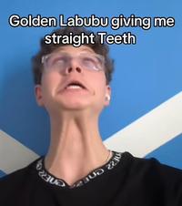 A meme reading, "golden labubu giving me straight teeth." The meme comes from a TikTok video by @ishowsomebellyroll1.