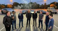 X user @samsheffer tweeted a photo os several tech CEOs standing in a parking lot, smoking, alongside the caption, "Caption this."