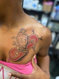 A tattoo that is meant to read "lost love." The tattoo has been misread to read "lo stve" and "lost steve."