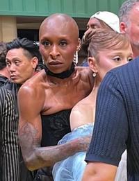 Photo of Cynthia Erivo hugging Ariana Grande protectively after a prankster rushed the red carpet to put his hands around her. 