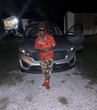 A photo of singer Neace Robinson from "Facebook":https://knowyourmeme.com/memes/sites/facebook-meta. She's most known as the "Funeral Stud" for singing her song "I Wished that Heaven Had a Phone" at a funeral.