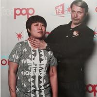 A photo of a fan requesting that Mads Mikkelsen choke them during a photo op.