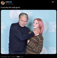 A post by Twitter user @catiescos. The tweet shares a photo of her being choked by Mads Mikkelsen and claiming it felt really good.