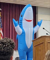 A Grok edit of Camila Parker. She is now in a shark suit.