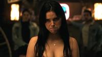 An image of Nikki from the 2026 horror movie "Obsession" frowning or pouting. She is sitting at a dinner table in a restaurant.