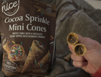 nice DELICIOUS: CALORIES PER SERVING SEE NUTRITION INFORMATION FOR FAT AND SATURATED FAT CONTENT Cocoa Sprinkle Mini Cones WAFFLE CONES WITH A CHOCOLATEY FILLING TOPPED WITH RAINBOW SPRINKLES 100% TISFACTION GUARANTEED LARGED TO SHOW DETA