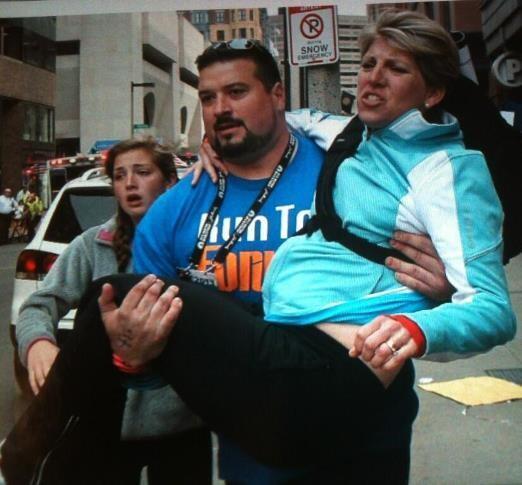 This is former New England Patriots guard Joe Andruzzi (3 time super bowl champion) carrying an injured woman away from scene.

And get this, Andruzzi is a cancer survivor too.