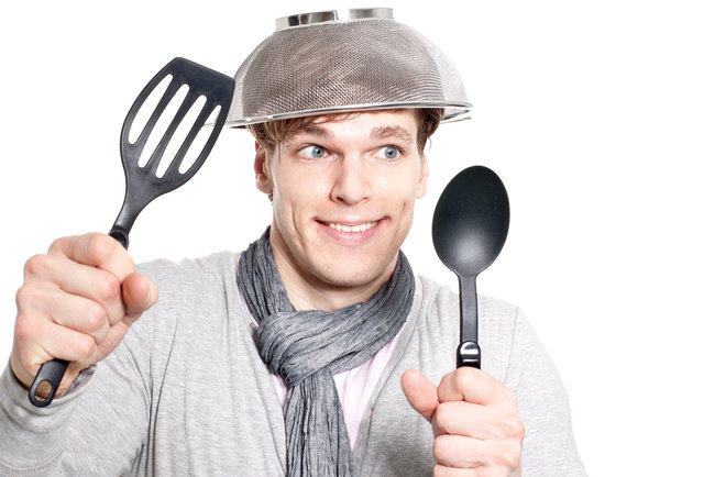 stock photo of man looking goofy and wearing a collander on his head