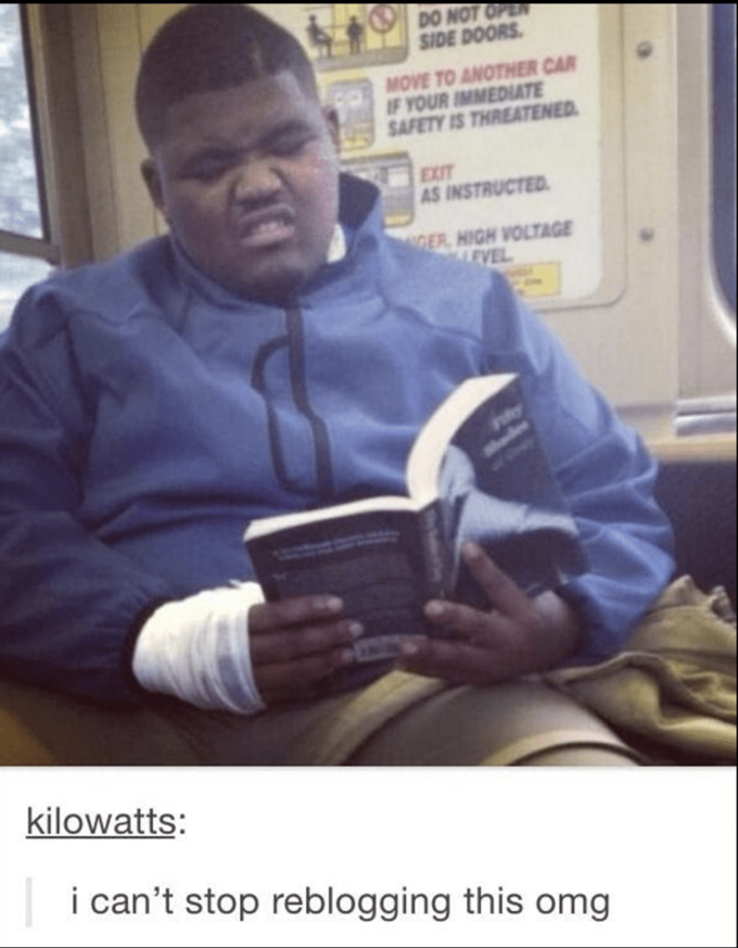 Meme of a young black man reading the 50 Shades book and making a W-- face as he looks at the words.