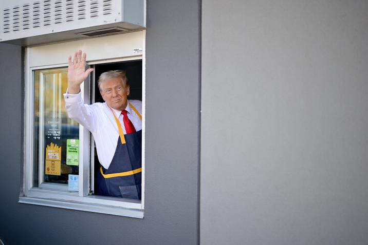 Photograph of the United States presidential candidate and former president Donald Trump waving from a drive-thru window during his October 2024 photo op at a McDonald's restaurant in Pennsylvania