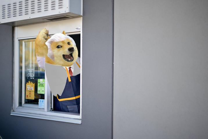 Photograph of the United States presidential candidate and former president Donald Trump waving from a drive-thru window during his October 2024 photo op at a McDonald's restaurant in Pennsylvania with Doge replacing Donald Trump