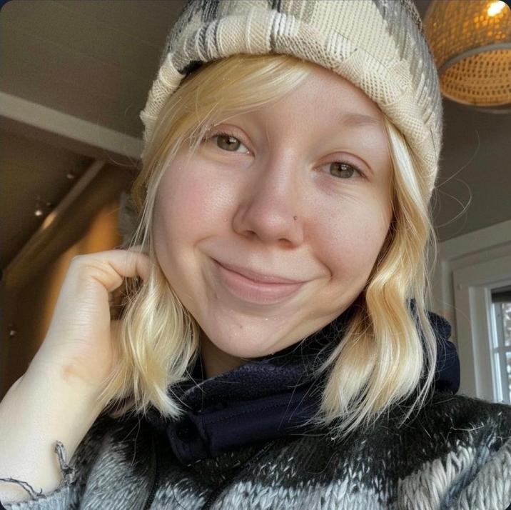 RadFem Hitler's face reveal. She's blonde, wearing a grey beanie and posing for a "selfie":https://knowyourmeme.com/memes/selfie.