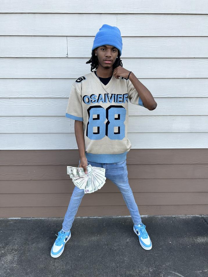 A Black man wearing blue skinny jeans, an Osaivier shirt and a blue beanie flexing cash in a fit pic. The image was later "photoshopped":https://knowyourmeme.com/memes/sites/photoshop to show him with one leg. Another edit showed him as a rocket ship. The image later inspired video creator "Jeremiah Springfield":https://knowyourmeme.com/memes/people/jeremiah-springfield