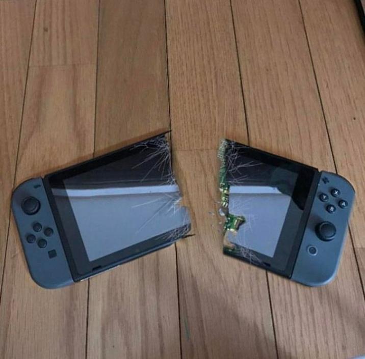 The original photoshop of a Nintendo Switch broken in half.