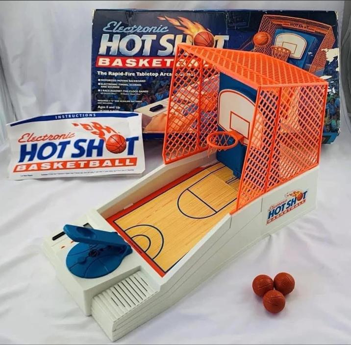 INSTRUCTIONS Electronic HOT SH BASKET The Rapid-Fire Tabletop Arca m MOTORIZED MOVING BACKBOARD WELECTRONIC TIMING SCORING AND SOUNDS RACE AGAINST THE CLOCK GAMES Ages 3 and Up Electronic HOT SHOT BASKETBALL HOTSHOT HOTSHOT