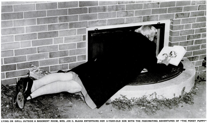 LYING ON GRILL OUTSIDE A BASEMENT ROOM, MRS. JOE C. BLAHA ENTERTAINS HER 6-YEAR-OLD SON WITH THE FASCINATING ADVENTURES OF "THE POKEY PUPPY"