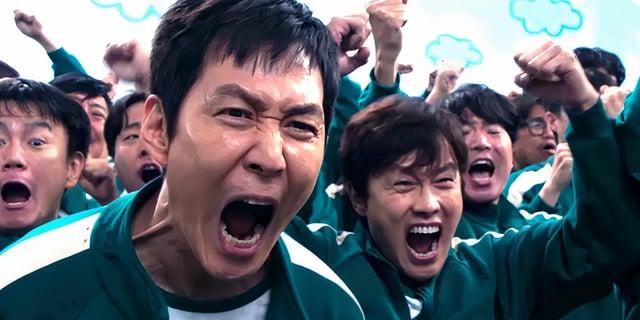 A "meme":https://knowyourmeme.com/memes/memes template from season 2 of the South Korean "Netflix":https://knowyourmeme.com/memes/sites/netflix show "_Squid Game_":https://knowyourmeme.com/memes/subcultures/squid-game in which the protagonist, "Seong Gi-hun":https://knowyourmeme.com/memes/seong-gi-huns-id-photo (Player 456), is cheering and celebrating with a group of players during the Six-Legged Pentathlon game in episode 5, titled "One More Game."
