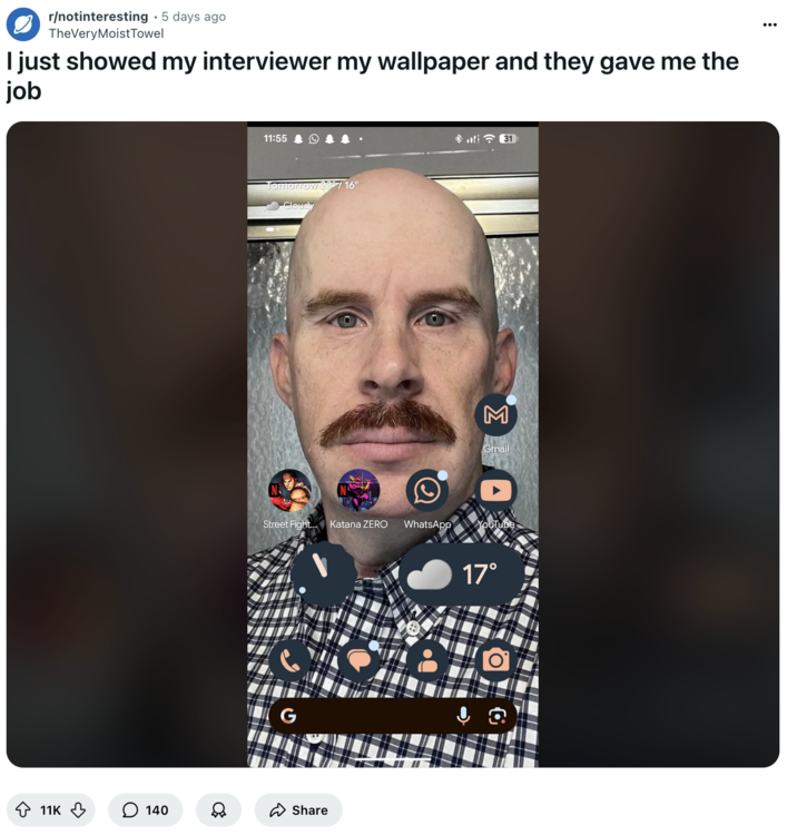 Redditor u/TheVeryMoistTowel riffed on the "John Interview" jokes on r/notinteresting, posting a photo of a phone background with u/COKE-SLURPEE's selfie on it. The photo showed a bald man with a mustache and a piercing gaze staring into the camera. 