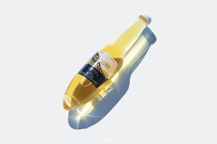 Slide 1 Beach Corona Bottle Post by Kenji Abe Japanese designer Kenji Abe created the "Glass bottle to stand on the beach" as part of an International Conference on Design for Ocean Environments. The rounded bottom of the Corona beer bottle is intended to allow for it to stand upright in the sand when there are no flat surfaces nearby.