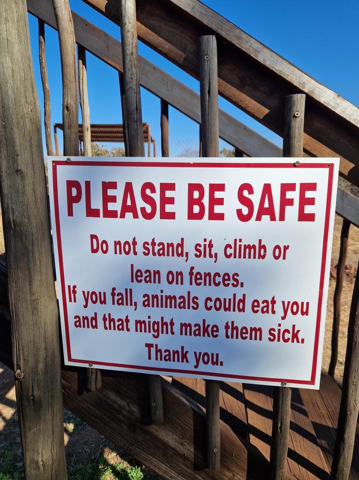PLEASE BE SAFE Do not stand, sit, climb or lean on fences. If you fall, animals could eat you and that might make them sick. Thank you.