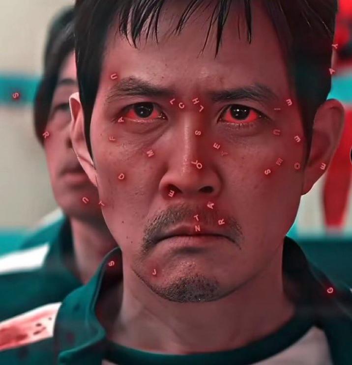 A "reaction images":https://knowyourmeme.com/memes/reaction-images from a "_Squid Game_":https://knowyourmeme.com/memes/subcultures/squid-game edit, showing the character "Seong Gi-hun":https://knowyourmeme.com/memes/seong-gi-huns-id-photo and random letters on his face.
