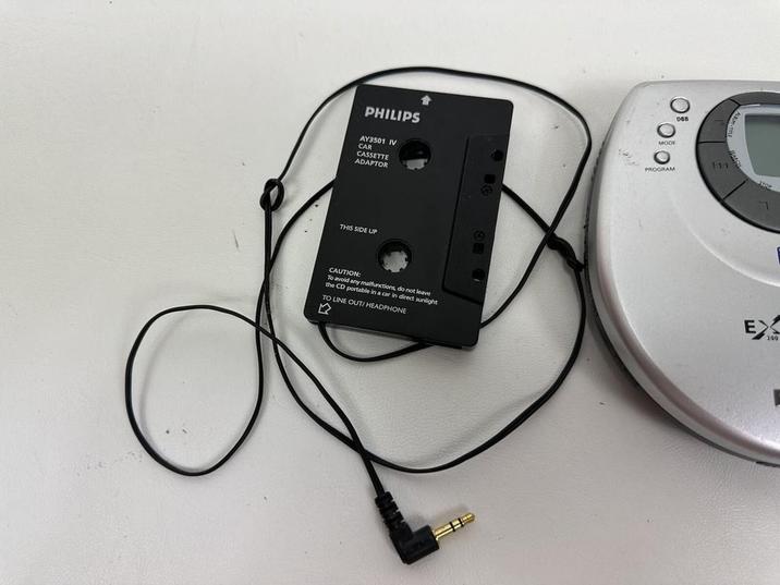 PHILIPS AY3501 IV CAR CASSETTE ADAPTOR 1000 MODE PROGRAM THIS SIDE UP CAUTION: To avoid any malfunctions, do not leave the CD portable in a car in direct sunlight TO LINE OUT! HEADPHONE 111 STOP EX 200