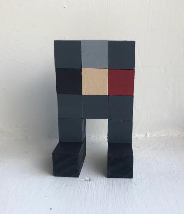 Collection of Eefo fan art including wooden blocks, crochet dolls, and digital variations