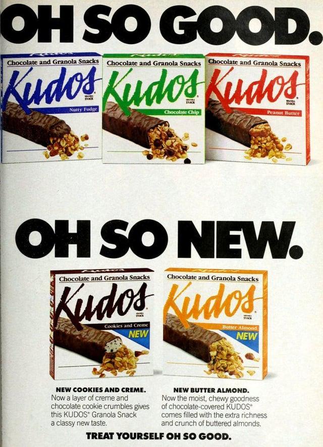 OH SO GOOD. Chocolate and Granola Snacks Chocolate and Granola Snacks Chocolate and Granola Snacks Kudos Kudos Kudos Nutty Fudge Chocolate Chip Peanut Butter OH SO NEW. Kudos Kudos Chocolate and Granola Snacks Chocolate and Granola Snacks Cookies and Creme NEW SACK Butter Almond NEW NEW COOKIES AND CREME. Now a layer of creme and chocolate cookie crumbles gives this KUDOS Granola Snack a classy new taste. NEW BUTTER ALMOND. Now the moist, chewy goodness of chocolate-covered KUDOS* comes filled with the extra richness and crunch of buttered almonds. TREAT YOURSELF OH SO GOOD.