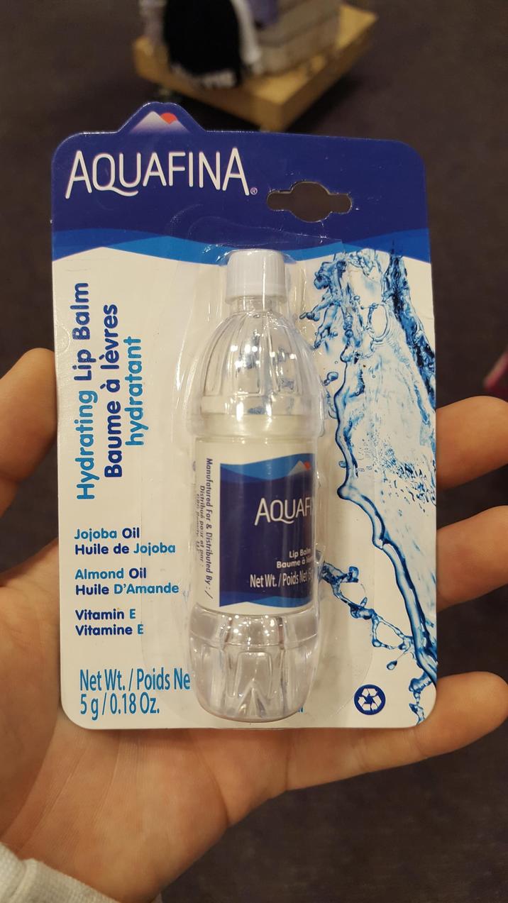 AQUAFINA Hydrating Lip Balm Baume à lèvres hydratant Jojoba Oil Huile de Jojoba Almond Oil Huile D'Amande Vitamin E Vitamine E Net Wt./Poids Ne 5g/0.18 Oz. Distribué pour of par Manufatured For & Distributed By AQUAF Lip Bal Baume à l Net Wt./Poids Net