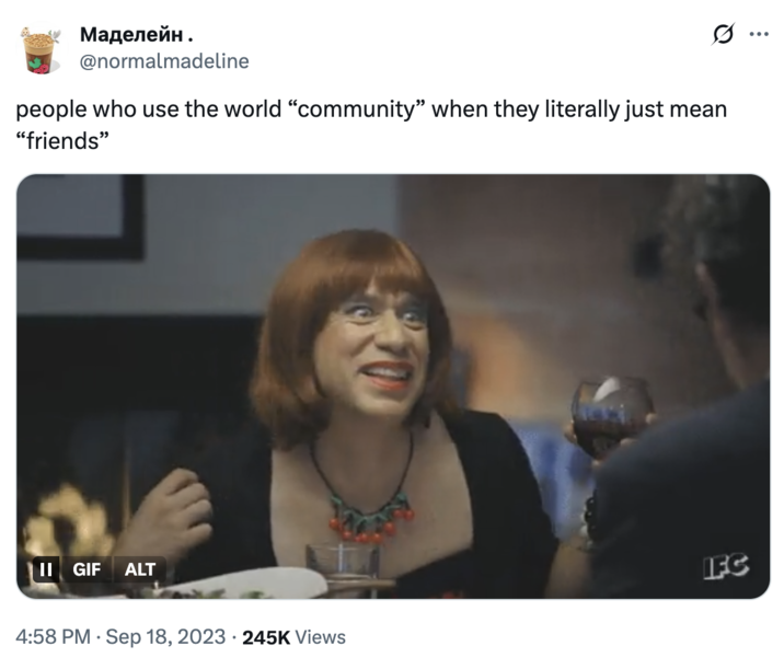 X user @normalmadeline tweeted, "people who use the world “community” when they literally just mean “friends”," alongside a GIF of Fred Armisen in a red wig looking around the dinner table.