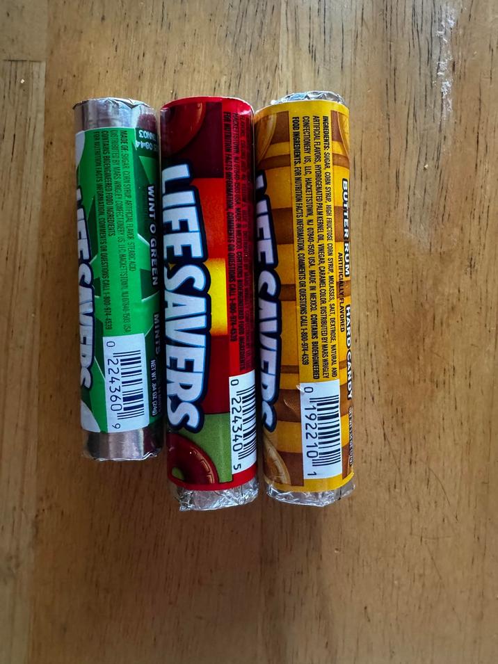BUTTER RUM HARD CANDY MINIMOLORS ARTIFICIALLY FLAVORED INGREDIENTS: SUGAR, CORN SYRUP, HIGH FRUCTOSE CORN SYRUP, MOLASSES, SALT, DEXTROSE, NATURAL AND ARTIFICIAL FLAVORS, HYDROGENATED PALM KERNEL OIL, VINEGAR, CARAMEL COLOR. DISTRIBUTED BY MARS WRIGLEY CONFECTIONERY US, LLC, HACKETTSTOWN, NJ 07840-1503 USA. MADE IN MEXICO. CONTAINS BIOENGINEERED FOOD INGREDIENTS. FOR NUTRITION FACTS INFORMATION, COMMENTS OR QUESTIONS CALL 1-800-974-4539 01922101 CESAVEDS FLAVORS, COLORS RED 40 YELLOW 5, BLUE 1 DISTRIBUTED BY MARS WRIGLEY CONFECTIONERY US, LLC HACKETTSTOWN, NJ 07840-1503 USA. MADE IN MEXICO. CONTAINS BIOENGINEERED FOOD INGREDIENTS FOR NUTRITION FACTS INFORMATION, COMMENTS OR QUESTIONS CALL 1-800-974-4539 02243405 LIFE SAVERS 08-44 NO3 WINT O GREEN MINTS NET WT 84 OZ (240) MADE GF: SUGAR, CORN SYRUP, ARTIFICIAL FLAVOR, STEARIC ACID DISTRIBUTED BY MARS WRIGLEY CONFECTIONERY US. LIC, HACKETTSTOWN, NJ 07840-1503 USA CONTAINS BIOENGINEERED FOOD INGREDIENTS FOR NUTRITION FACTS INFORMATION, COMMENTS OR QUESTIONS CALL 1-800-974-4539 02243609 VEDS